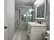 Modern bathroom showcasing a vanity with a marble countertop, framed mirror, sliding glass shower door, and gray walls at 2173 Annie Laura Ln, Mount Pleasant, SC 29466