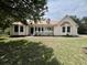 Charming one-story home with a light yellow exterior, a copper-colored metal roof and a well-manicured front lawn at 2173 Annie Laura Ln, Mount Pleasant, SC 29466