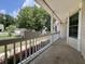 Covered front porch with white railings, planter boxes, and views of the surrounding neighborhood and mature trees at 2173 Annie Laura Ln, Mount Pleasant, SC 29466