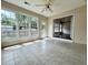 Bright sunroom with tiled flooring, multiple windows, and a ceiling fan for comfortable relaxation at 2173 Annie Laura Ln, Mount Pleasant, SC 29466