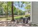 Idyllic backyard view showcasing a serene pond, lush greenery, and air conditioning units at 2317 Tall Sail Dr # 1005, Charleston, SC 29414
