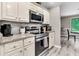 Modern kitchen with stainless steel appliances, granite countertops, and elegant white cabinets at 2317 Tall Sail Dr # 1005, Charleston, SC 29414