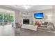 Cozy living room featuring a stone fireplace, mounted TV, and comfortable sectional sofa at 2317 Tall Sail Dr # 1005, Charleston, SC 29414
