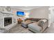 Comfortable living room with a stone fireplace, TV, and sectional sofa, ideal for relaxation at 2317 Tall Sail Dr # 1005, Charleston, SC 29414