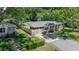 Aerial view of a brick house, covered parking area, privacy fence, and tree-filled lot at 2515 Violet Ave, North Charleston, SC 29405