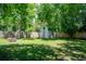 Large backyard with lush green grass, brick fire pit, storage shed and privacy fence at 2515 Violet Ave, North Charleston, SC 29405
