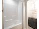 Clean bathroom showing the tub and shower with shelving and towel storage at 2515 Violet Ave, North Charleston, SC 29405