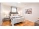 Bright bedroom with hardwood floors, natural light, stylish furniture, and a decorative piece at 2515 Violet Ave, North Charleston, SC 29405