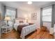 Comfortable bedroom with hardwood floors, natural light, and well-appointed furniture at 2515 Violet Ave, North Charleston, SC 29405