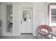 Inviting entrance featuring a white-painted brick wall, a half-glass door, and a decorative chair at 2515 Violet Ave, North Charleston, SC 29405