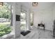 Inviting entryway with white brick walls, contemporary lighting, and views of the front yard at 2515 Violet Ave, North Charleston, SC 29405