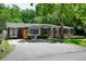 Charming brick home featuring a carport, mature trees, and a well-manicured lawn at 2515 Violet Ave, North Charleston, SC 29405