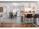 Open kitchen and dining area with pendant lighting, hardwood floors, and modern design at 2515 Violet Ave, North Charleston, SC 29405