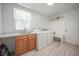 Bright laundry room featuring a sink, wood cabinets, washer, dryer, and wood-look floors at 2515 Violet Ave, North Charleston, SC 29405