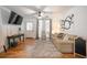Cozy living room features hardwood floors, neutral decor, a ceiling fan, and large windows at 2515 Violet Ave, North Charleston, SC 29405