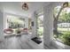 Bright sunroom with large windows, whitewashed brick, and views of the outdoor landscape at 2515 Violet Ave, North Charleston, SC 29405