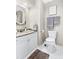 This bathroom features a granite countertop, white cabinets, toilet, mirror, and towel rack at 2655 Gnarled Pine, Seabrook Island, SC 29455