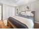 Bedroom featuring a large closet, window with wooden shutters, ceiling fan, and coastal themed decor at 2655 Gnarled Pine, Seabrook Island, SC 29455
