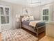 Bedroom featuring two windows with wooden shutters, a ceiling fan, and coastal themed decor at 2655 Gnarled Pine, Seabrook Island, SC 29455