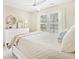 Bedroom featuring a ceiling fan, dresser, window with shutters and coastal decor at 2655 Gnarled Pine, Seabrook Island, SC 29455