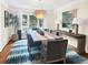 Elegant dining room with a stylish chandelier, seating for eight, and serene outdoor views at 2655 Gnarled Pine, Seabrook Island, SC 29455