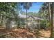 Exterior shot of a home showcasing its architecture, surrounding landscaping, and backyard deck at 2655 Gnarled Pine, Seabrook Island, SC 29455