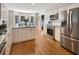 Modern kitchen with custom white cabinets, stainless steel appliances, and a large granite island at 2655 Gnarled Pine, Seabrook Island, SC 29455