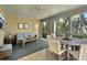 Relaxing screened-in porch with ceiling fan, comfortable seating, and views of the lush surroundings at 2655 Gnarled Pine, Seabrook Island, SC 29455