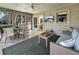 Inviting screened-in porch with comfortable seating, ceiling fan, and views of the yard at 2655 Gnarled Pine, Seabrook Island, SC 29455