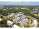 Aerial view of tennis courts with lush landscaping and a nearby lake, creating a serene sports environment at 2655 Gnarled Pine, Seabrook Island, SC 29455