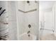 Bathroom shower featuring tiled walls with decorative accents and brushed nickel fixtures at 283 Saxony Loop, Summerville, SC 29486