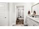 Bathroom featuring a vanity with a granite countertop, white cabinets, and hallway views at 283 Saxony Loop, Summerville, SC 29486