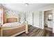 Bright bedroom with four-poster bed, vanity, and wood-look flooring at 283 Saxony Loop, Summerville, SC 29486