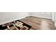 Spacious bedroom with hardwood floors, white trim, and a geometric rug at 283 Saxony Loop, Summerville, SC 29486