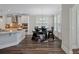 Cozy breakfast nook bathed in light, featuring a dark wood table and a view of the kitchen at 283 Saxony Loop, Summerville, SC 29486