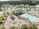Aerial view of community amenities including a pool, clubhouse, playground, and green spaces at 283 Saxony Loop, Summerville, SC 29486