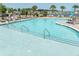 Sparkling community pool with lounge chairs and umbrellas, perfect for relaxation and recreation at 283 Saxony Loop, Summerville, SC 29486