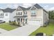 Beautiful two-story home featuring a well-kept lawn, covered porch, and attached two-car garage at 283 Saxony Loop, Summerville, SC 29486