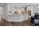 Open-concept kitchen with stone countertops and stainless appliances flows into breakfast and dining areas at 283 Saxony Loop, Summerville, SC 29486