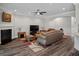 Comfortable living room with fireplace, TV, leather furniture, and hardwood floors at 283 Saxony Loop, Summerville, SC 29486
