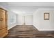Open bedroom showcasing wood flooring and natural light from windows at 283 Saxony Loop, Summerville, SC 29486