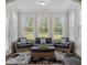 Light-filled sunroom with wicker furniture offers views of the landscaped exterior and a tranquil atmosphere at 283 Saxony Loop, Summerville, SC 29486
