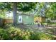 The backyard features a grassy area, large tree, and a green outbuilding at 2963 Alabama Dr, North Charleston, SC 29405