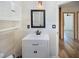 Well-lit bathroom featuring a vessel sink, wood-look tiling, and cabinet with sleek hardware at 2963 Alabama Dr, North Charleston, SC 29405