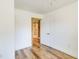 Bright bedroom featuring hardwood floors, white walls, and a door to an adjacent bathroom at 2963 Alabama Dr, North Charleston, SC 29405