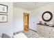 Bright bedroom showcases light-colored wooden floors, stylish art, and a glimpse into the ensuite bathroom at 2963 Alabama Dr, North Charleston, SC 29405