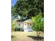 View of the home's exterior showcasing its quaint size, green siding, and well-maintained front lawn at 2963 Alabama Dr, North Charleston, SC 29405