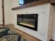 Modern electric fireplace with white brick surround and reclaimed wood mantel at 2963 Alabama Dr, North Charleston, SC 29405