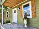 Charming front porch with a white door, wood shutters, and a decorative flower pot adds curb appeal at 2963 Alabama Dr, North Charleston, SC 29405