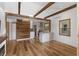 Open concept living room with wood floors and beamed ceilings that flows into the kitchen at 2963 Alabama Dr, North Charleston, SC 29405